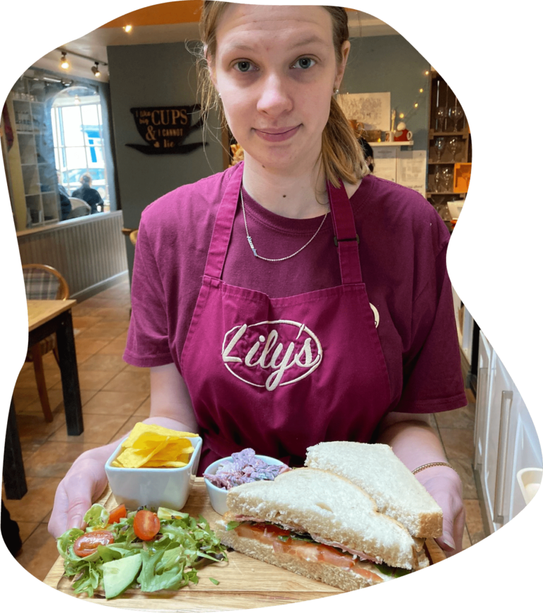 Lilys Staff Member serving sandwiches